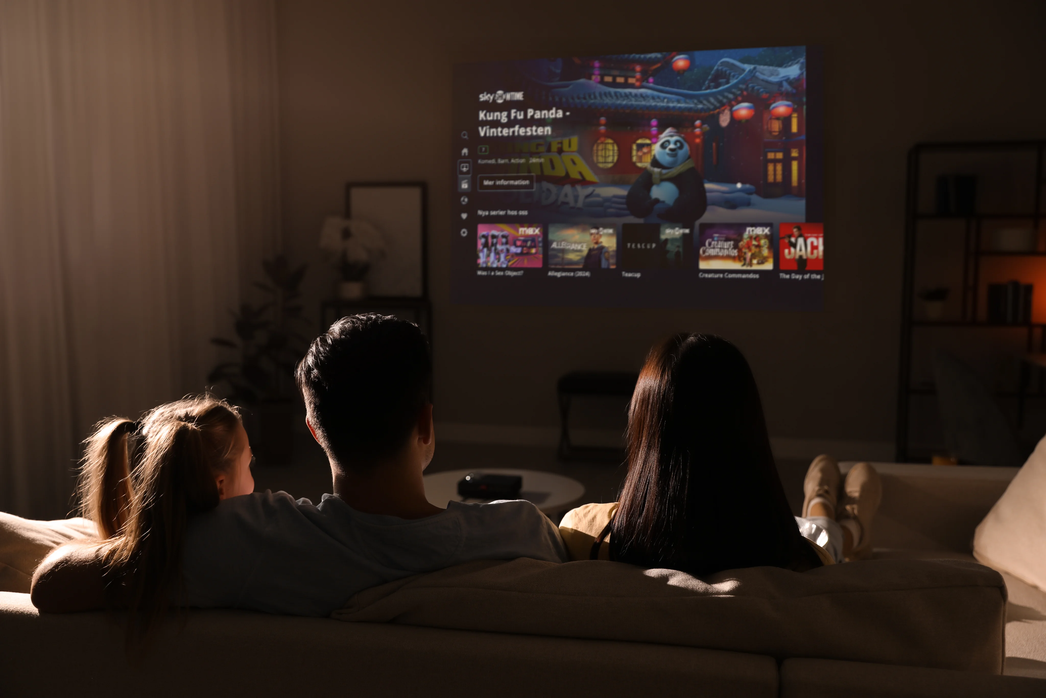 People sitting on a couch watching TV