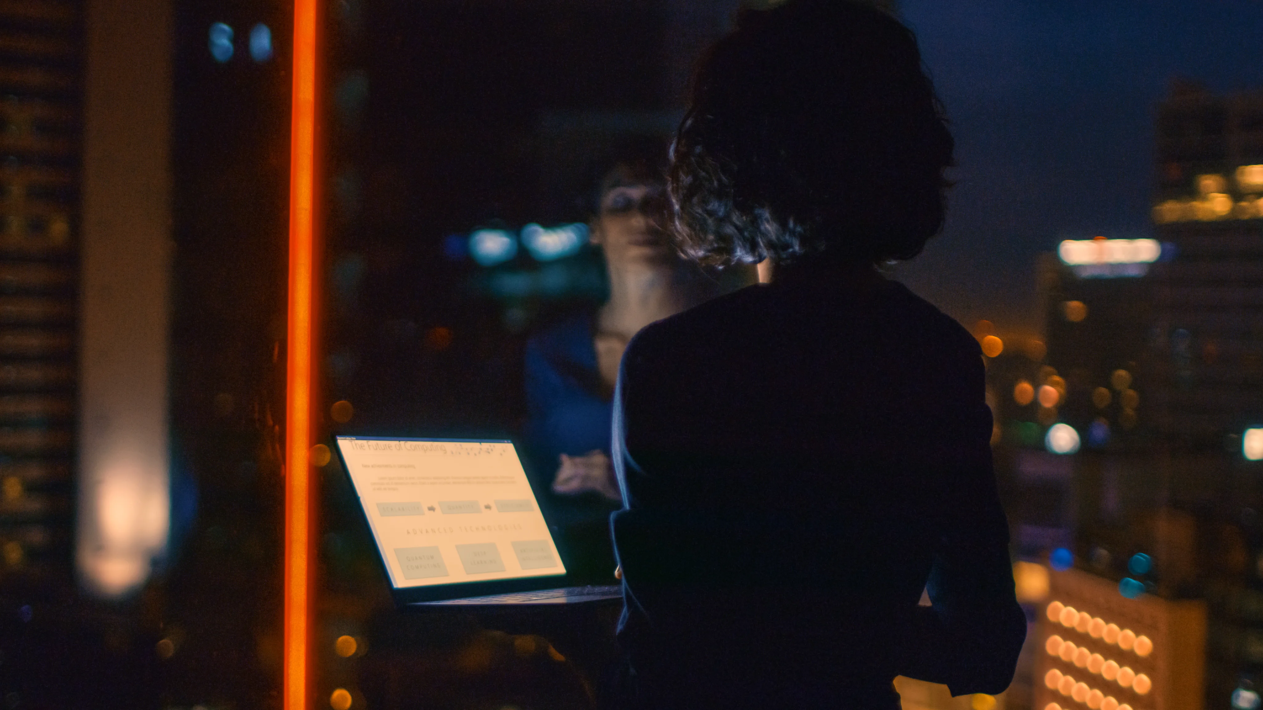 Person in the dark with a laptop