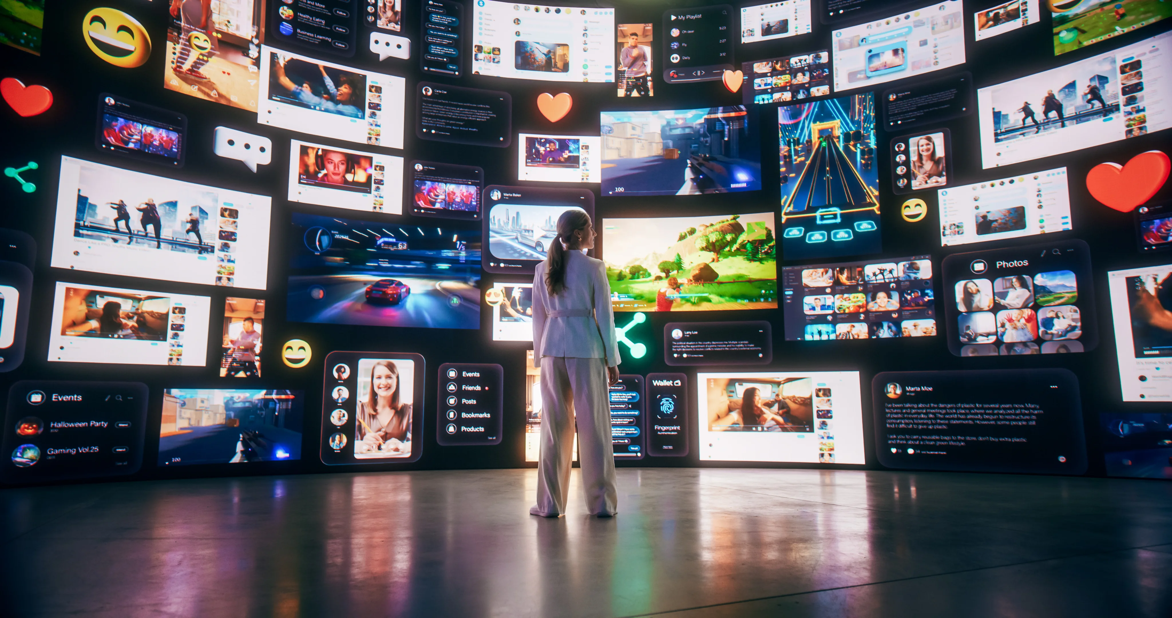 Person standing in front of a wall of digital screens.