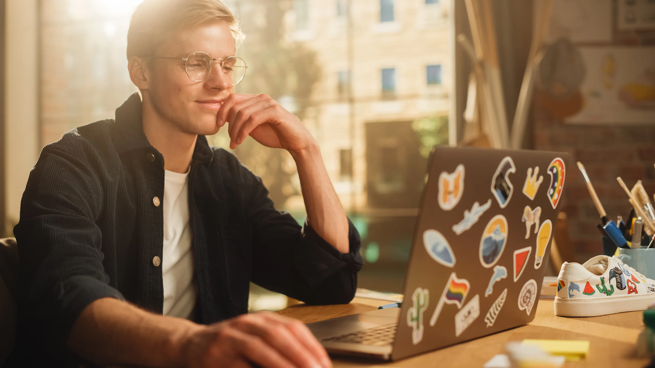 Man in glasses sitting happy